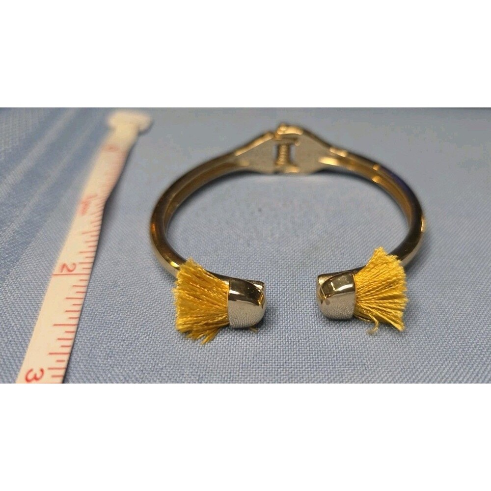 Gold Tone Hinged Cuff Bracelet with Yellow Tassel Ends